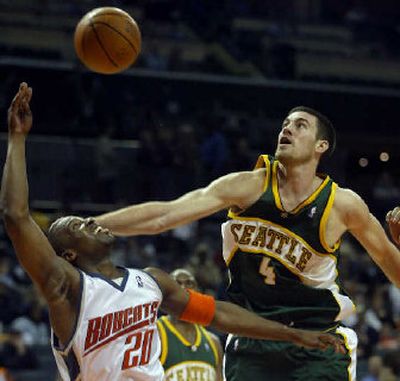
Raymond Felton, who helped lead Charlotte past Seattle on Monday night, is fouled by the Sonics' Nick Collison. 
 (Associated Press / The Spokesman-Review)