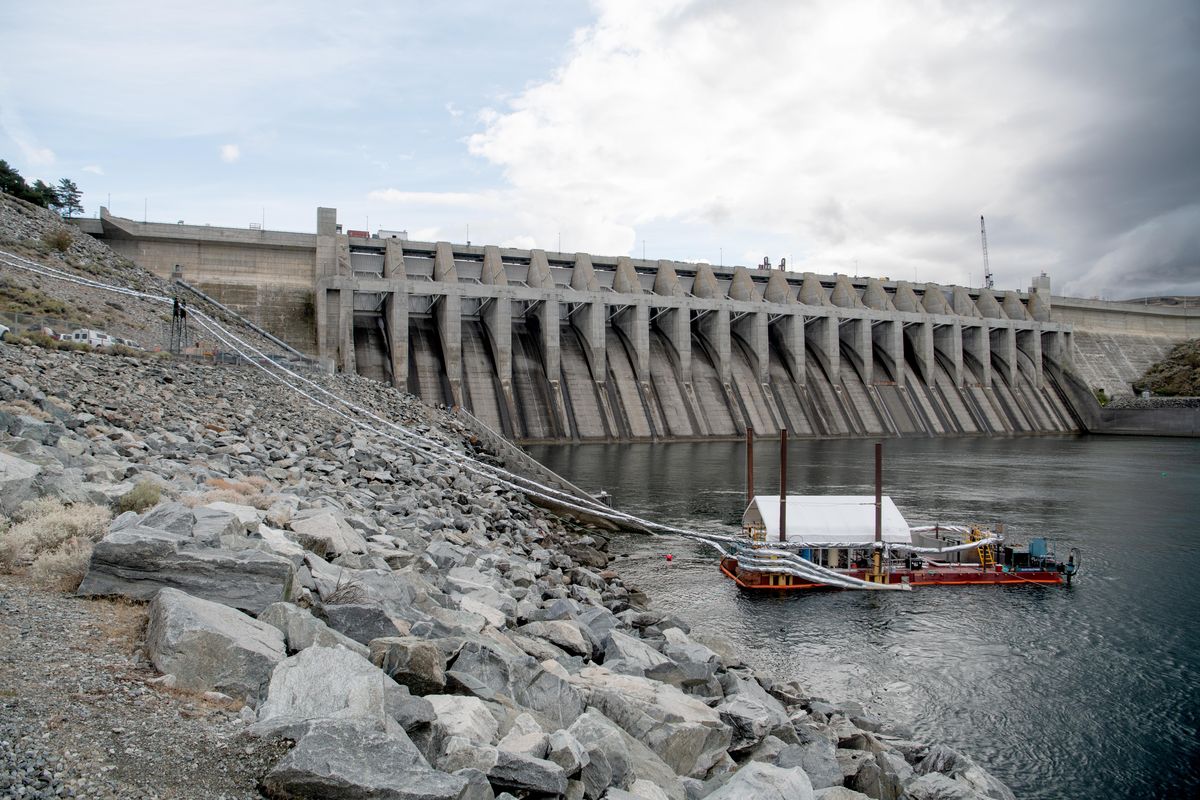 Whooshh Innovations machinery is set up on a barge at the Chief Joseph Dam in Bridgeport where the company wanted to show off its Whooshh Passage Portal, a system for moving salmon past hydroelectric dams, Tuesday, Sept. 10, 2019. The system picks up individual fish and shoots them through a flexible tube using water and air pressure. (Jesse Tinsley / The Spokesman-Review)