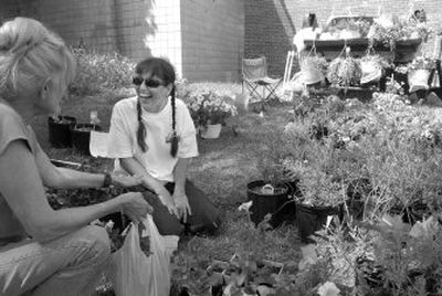 
Flower grower Paula Flodquist, second from left, chats with Lana Bernier at the Spirit Lake Farmers' Market. The market is held Fridays and Saturdays in downtown Spirit Lake. 
 (Jesse Tinsley / The Spokesman-Review)