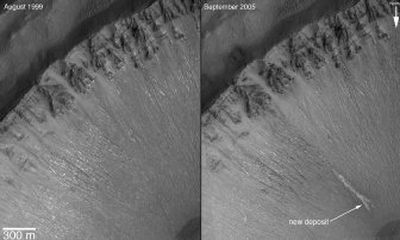 
These photos released by NASA show two views – taken six years apart – of a crater in the Centauri Montes region on Mars taken by NASA's Mars Global Surveyor. The image on the right, taken in 2005, shows an area with changes to the surface, suggesting that water occasionally flows on the frigid surface of Mars. 
 (Associated Press / The Spokesman-Review)