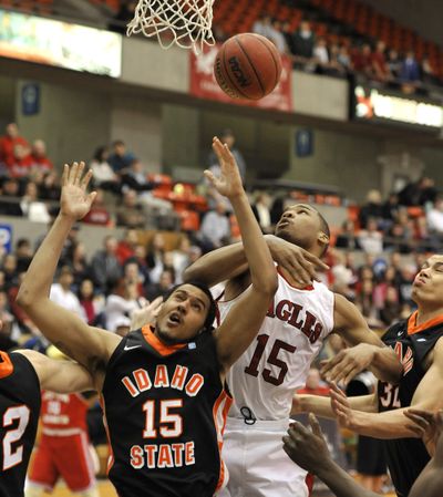 Eastern Washington University senior, Laron Griffin, roughs up Andre' Hachett of Idaho State University at Reese Court last Tuesday. (Dan Pelle)