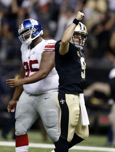 New Orleans Saints quarterback Drew Brees (9) reacts after throwing a touchdown pass to tie the game late in the second half of Sunday’s victory over the New York Giants. (Butch Dill / Associated Press)