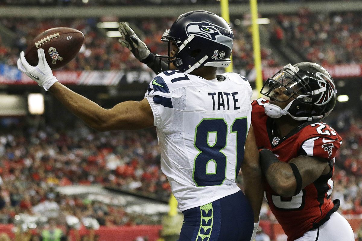 Seahawks wide receiver Golden Tate makes a one-handed touchdown catch while defended by Robert Alford at the end of first half. (Associated Press)