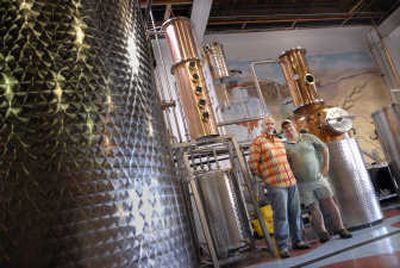 
Kent Fleischmann and Don Poffenroth, Dry Fly Distilling co-founders,  seen Monday with their still, say production could begin this week. 
 (Brian Plonka / The Spokesman-Review)