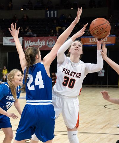 Pomeroy point guard Maddy Dixon  lines up a shot as Curlew forward Korin Baker  defends during a State 1B quarterfinal Thursday  in the Spokane Arena. (Colin Mulvany / The Spokesman-Review)