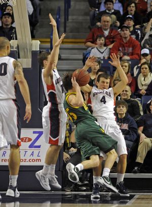 David Stockton, left, and Kevin Pangos, rear, of Gonzaga combine to stop the drive of Cody Doolin of San Francisco and cause a turnover. (Christopher Anderson)