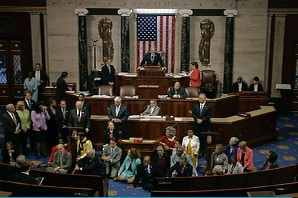 In this frame grab taken from AP video Georgia Rep. John Lewis, center, leads a sit-in of more than 200 Democrats in demanding a vote on measures to expand background checks and block gun purchases by some suspected terrorists in the aftermath of last week’s massacre in Orlando, Florida, that killed 49 people in a gay nightclub. (Associated Press)