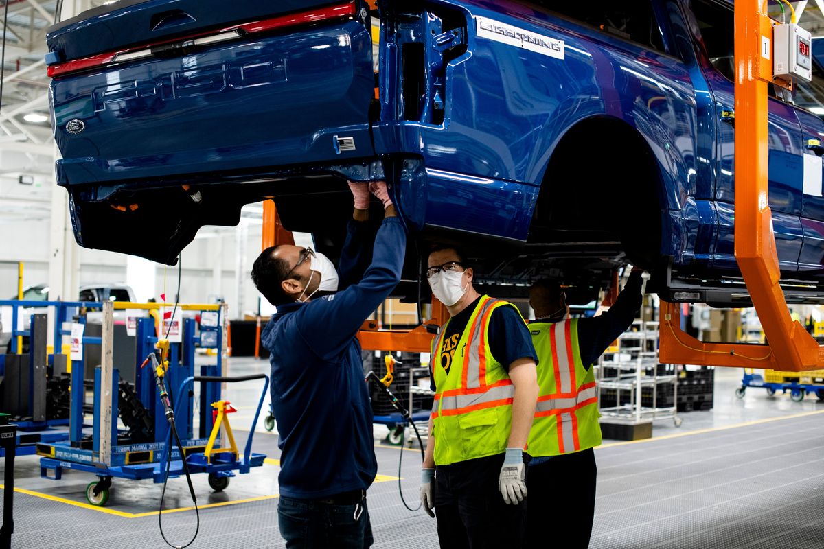 A 2022 Ford F-150 Lightning pickup, an electric vehicle, travels down the assembly line in January at a manufacturing facility in Dearborn, Mich.  (New York Times)