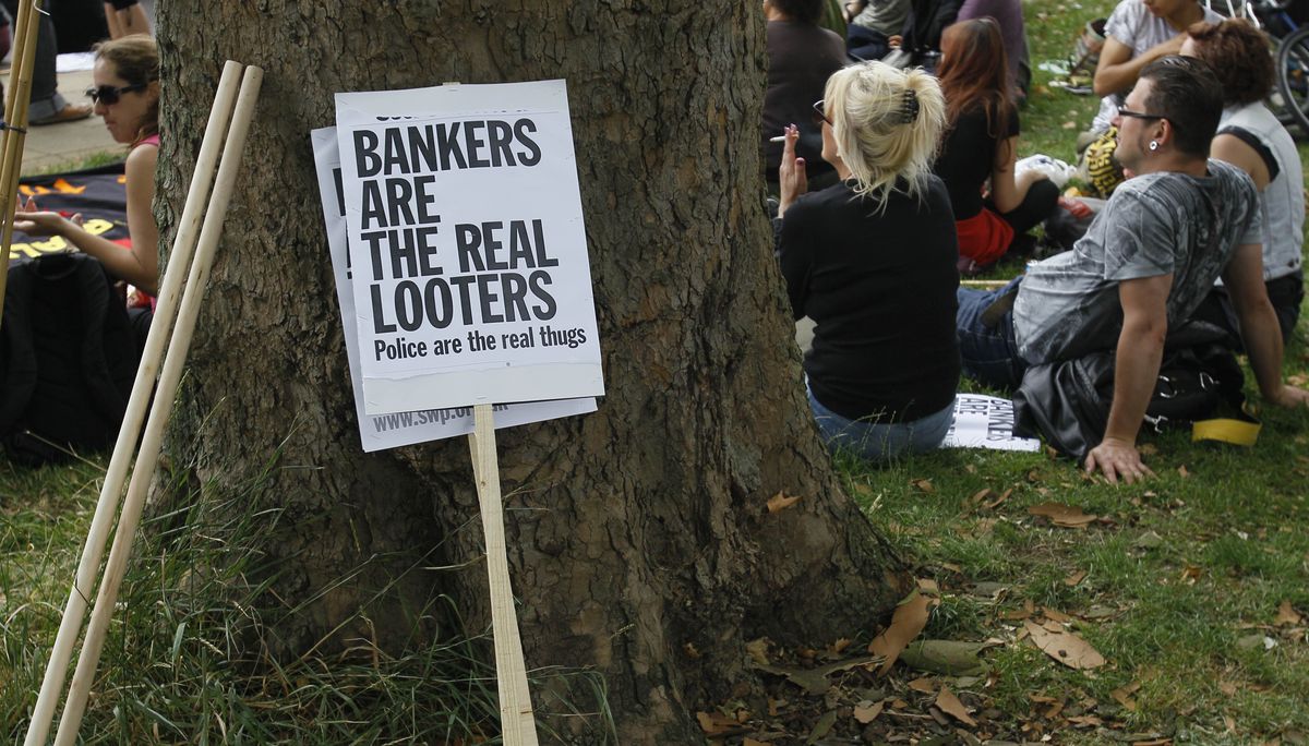 People gather at a peaceful demonstration in Tottenham in London on Saturday. The gathering came a week after violent riots broke out in the north London suburb. (Associated Press)