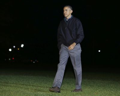 President Barack Obama walks across the South Lawn to the White House in Washington on Sunday. (Associated Press)
