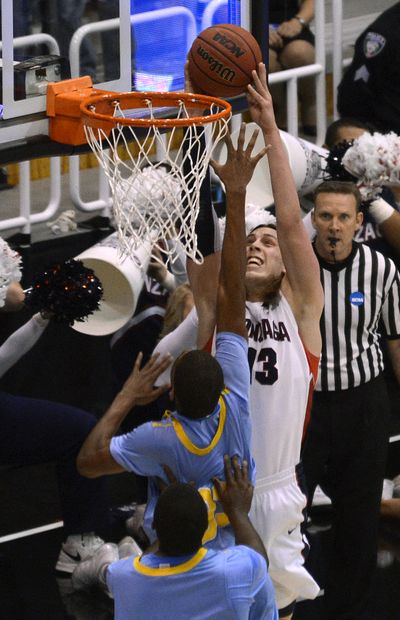 Gonzaga's Kelly Olynyk goes for a dunk attempt against Southern's Malcolm Miller in the 2nd half of their second round NCAA men's college basketball tournament game, Thursday at the EnergySolutions Arena in Salt Lake City, Utah.   (Dan Pelle)