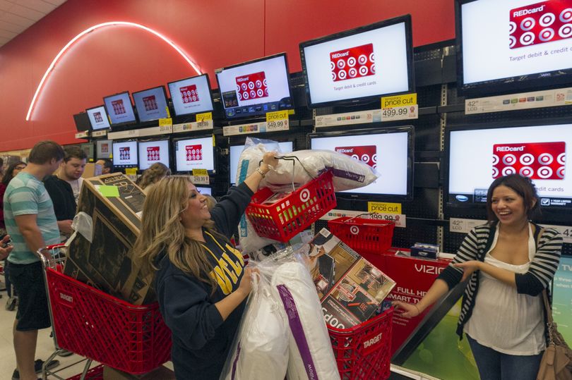 Roxanna Garcia, middle, waits in line to purchase gifts at the Target store in Burbank, Calif., on Nov. 22, 2012. Target will open earlier than ever this Thanksgiving, at 8 p.m. (Associated Press)