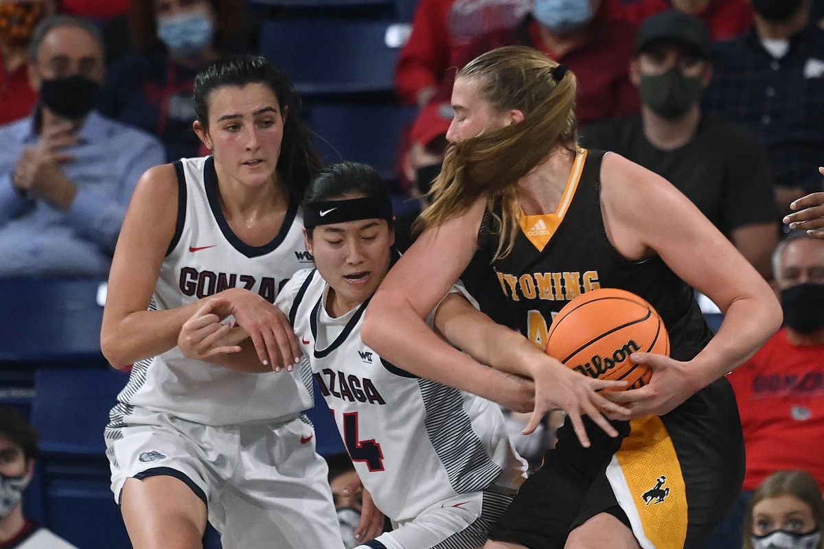 Gonzaga guard Kaylynne Truong (14) reaches in to dislodge the ball from Wyoming center Allyson Fertig (45) during the first half of a college basketball game, Friday, Dec. 3, 2021, in the McCarthey Athletic Center.  (COLIN MULVANY/THE SPOKESMAN-REVIEW)