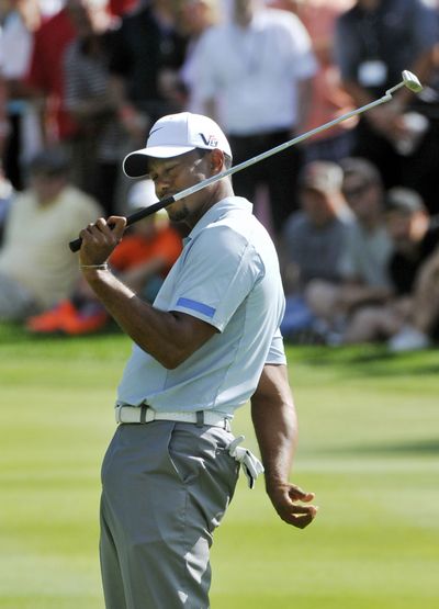 Tiger Woods fell back to earth Saturday, shooting a 2-under 68 a day after a 61 that tied his career best and set a course record. (Associated Press)