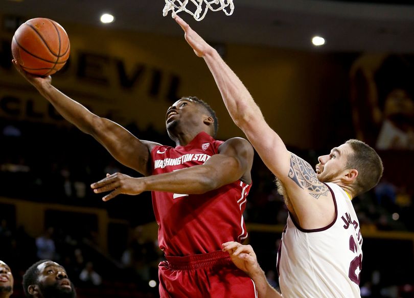 Washington State guard Ike Iroegbu, left, shoots as Arizona State forward Eric Jacobsen (21) defends during the first half of an NCAA college basketball game Thursday, Jan. 14, 2016, in Tempe, Ariz. (Matt York / AP)