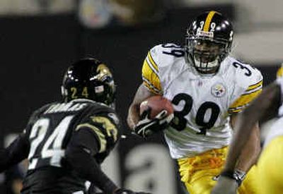 
Steelers running back Willie Parker looks for a way around Jaguars defender Kiwaukee Thomas during second-quarter action Sunday. 
 (Associated Press / The Spokesman-Review)