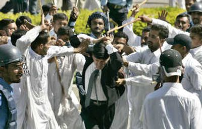 
Plainclothes police beat a lawyer during a clash Saturday in Islamabad, Pakistan. Associated Press
 (Associated Press / The Spokesman-Review)