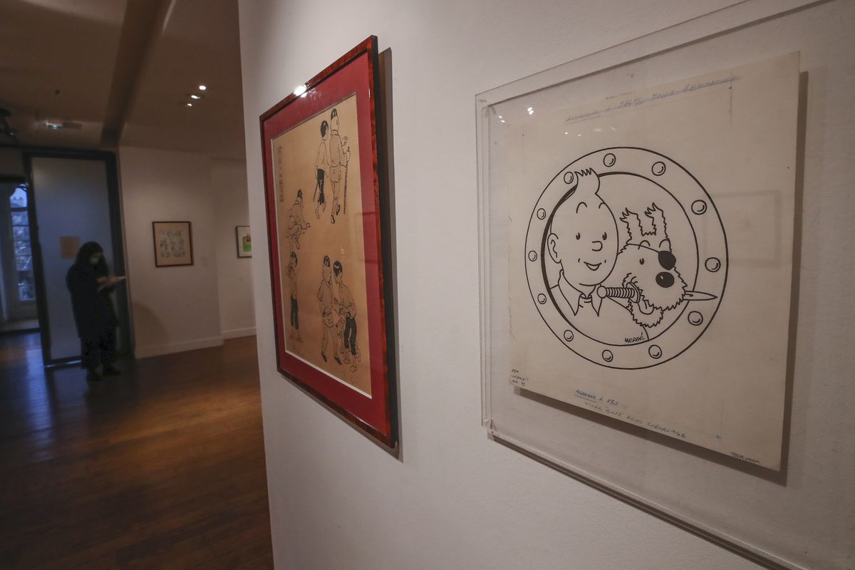 The Chinese inked on paper original of the comic character Tintin and his dog snowy as a pirate made for an advertising and drawn by Belgian creator Herge, is displayed at the Artcurial auction house in Paris, Wednesday, Jan. 13, 2021. The art work with an estimates value of 3000 to 5000 euros (US $ 3650 to 6080), is going on sale Thursday.  (Michel Euler)