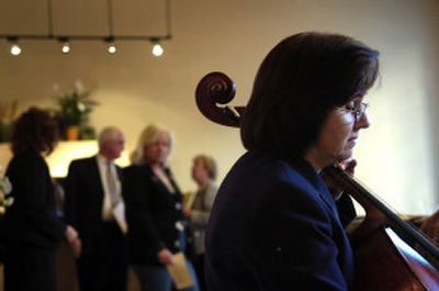 
Spokane Symphony cellist Janet Napoles plays at a symphony benefit called Music at the Lofts at a furnished condominium in the West 809 mixed-use building at Lincoln and Main in downtown Spokane on Sunday. 
 (Holly Pickett / The Spokesman-Review)
