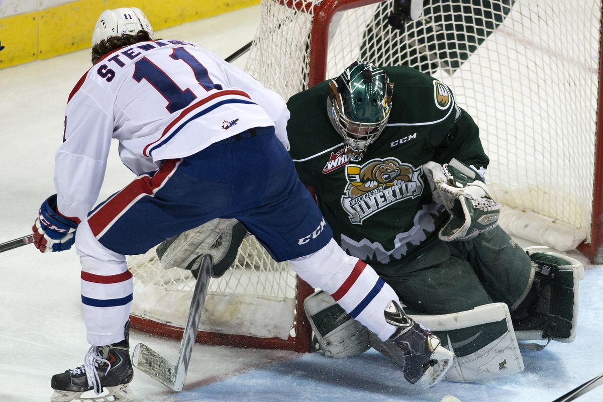 Silvertips goalie Carter Hart keeps Chiefs center Liam Stewart's puck away from the goal during the second period. (Colin Mulvany)