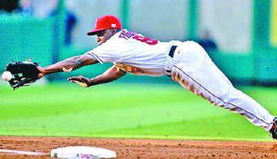 
Los Angeles' Chone Figgins lays out to snag a line drive by the Seattle Mariners' Kenji Johjima during the third inning  Monday. 
 (Associated Press / The Spokesman-Review)