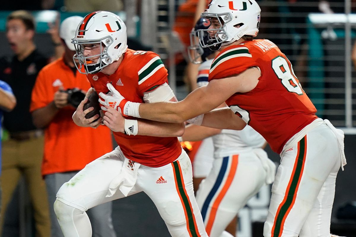 Miami quarterback Tyler Van Dyke (9) scores a touchdown as tight end Will Mallory (85) runs along side him during a game against Virginia on Sept. 30 in Miami Gardens, Florida. Despite COVID-19 issues in their program, the Hurricanes plan to play Washington State on Dec. 31 in the Sun Bowl.  (Associated Press)