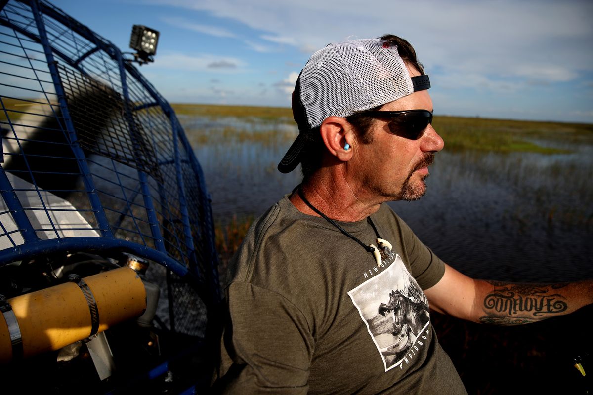 Python hunter Dave Hackathorn, 53, of Waverly, West Virginia, pilots his airboat through the Everglades on Aug. 12, 2022, west of Weston, Florida.    (Gary Coronado/Los Angeles Times/TNS)