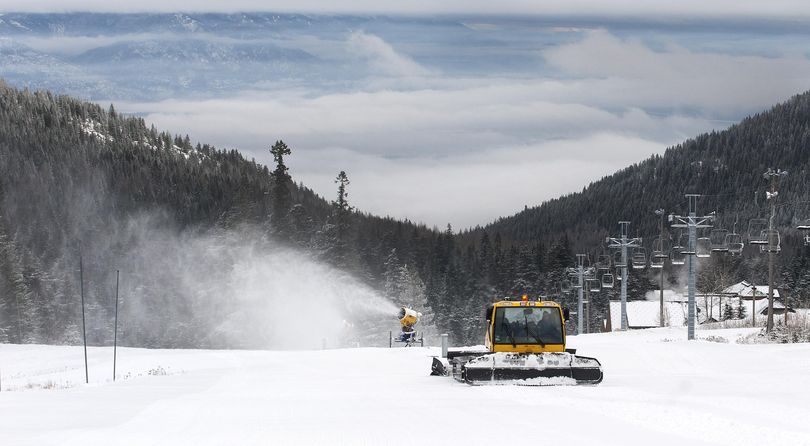 Schweitzer Mountain Resort grooming manager Dave Rowe drives past snow-making machines at the ski resort in Sandpoint, Idaho on Wednesday, Dec. 2, 2015. (Kathy Plonka / The Spokesman-Review)