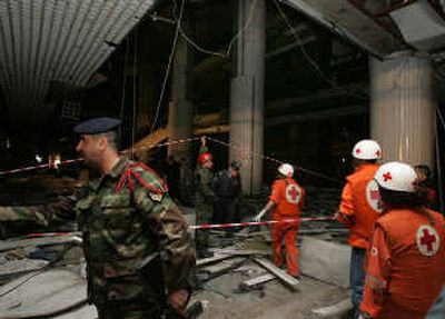 
Lebanese soldiers and Lebanese Red Cross workers check for casualties at the Alta Vista Shopping Center on the Kaslik stretch near Jounieh, the main Christian port city about 10 miles north of Beirut, Lebanon, early today. 
 (Associated Press / The Spokesman-Review)
