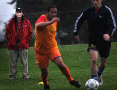 
Spokane Spiders owner Al Brown, background, watches his Premier Development League team practice at Plantes Ferry Park. 
 (Rajah Bose / The Spokesman-Review)