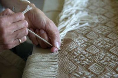 
JoDee Hickey  completes a blanket produced on her loom last month at the Quail Run Fiber Mill in Airway Heights.
 (The Spokesman-Review)