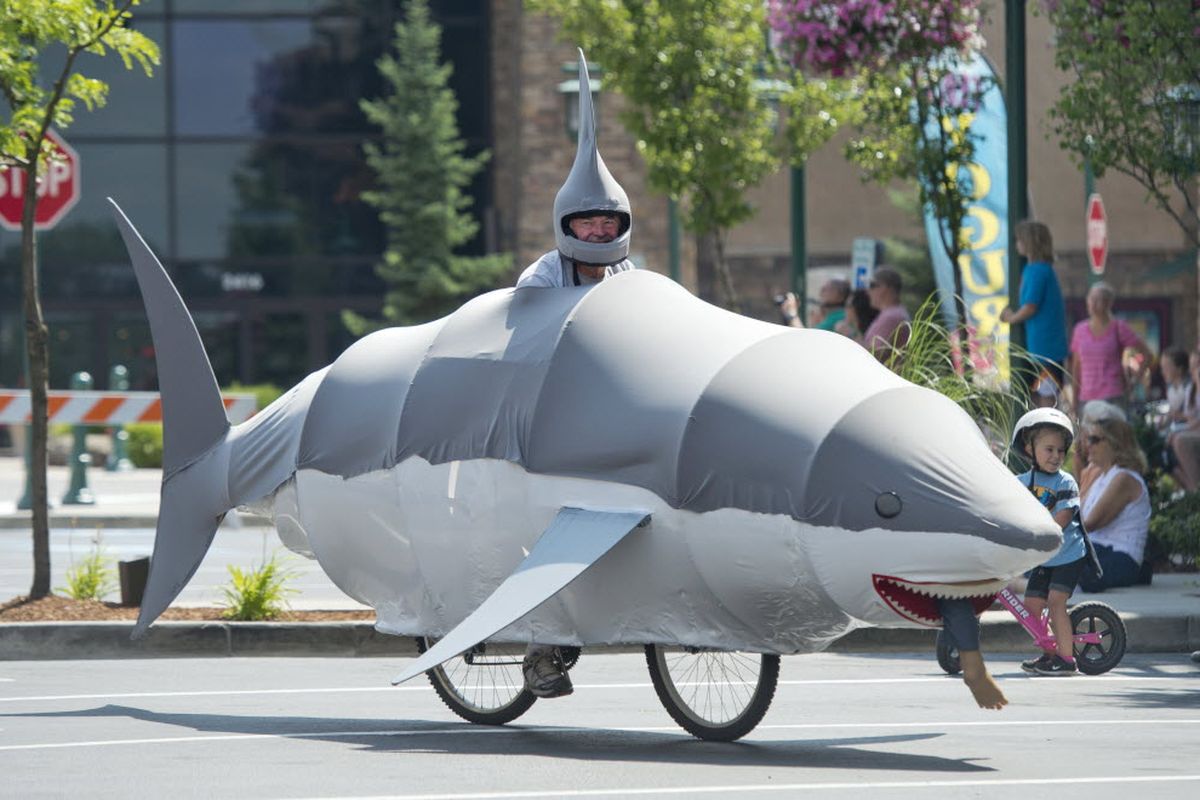 Ross Welburn of Hayden rides his shark cycle in the parade at Kinetic Fest, a daylong celebration of moving sculpture and human-powered transportation Saturday at the Riverstone development in Coeur d