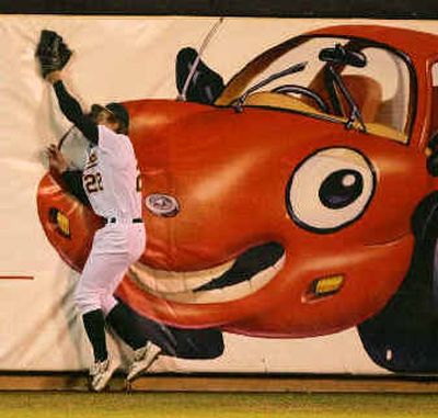 
Oakland left fielder Eric Byrnes robs Seattle's Jose Lopez of a base hit in the third inning Monday night in Oakland.
 (Associated Press / The Spokesman-Review)