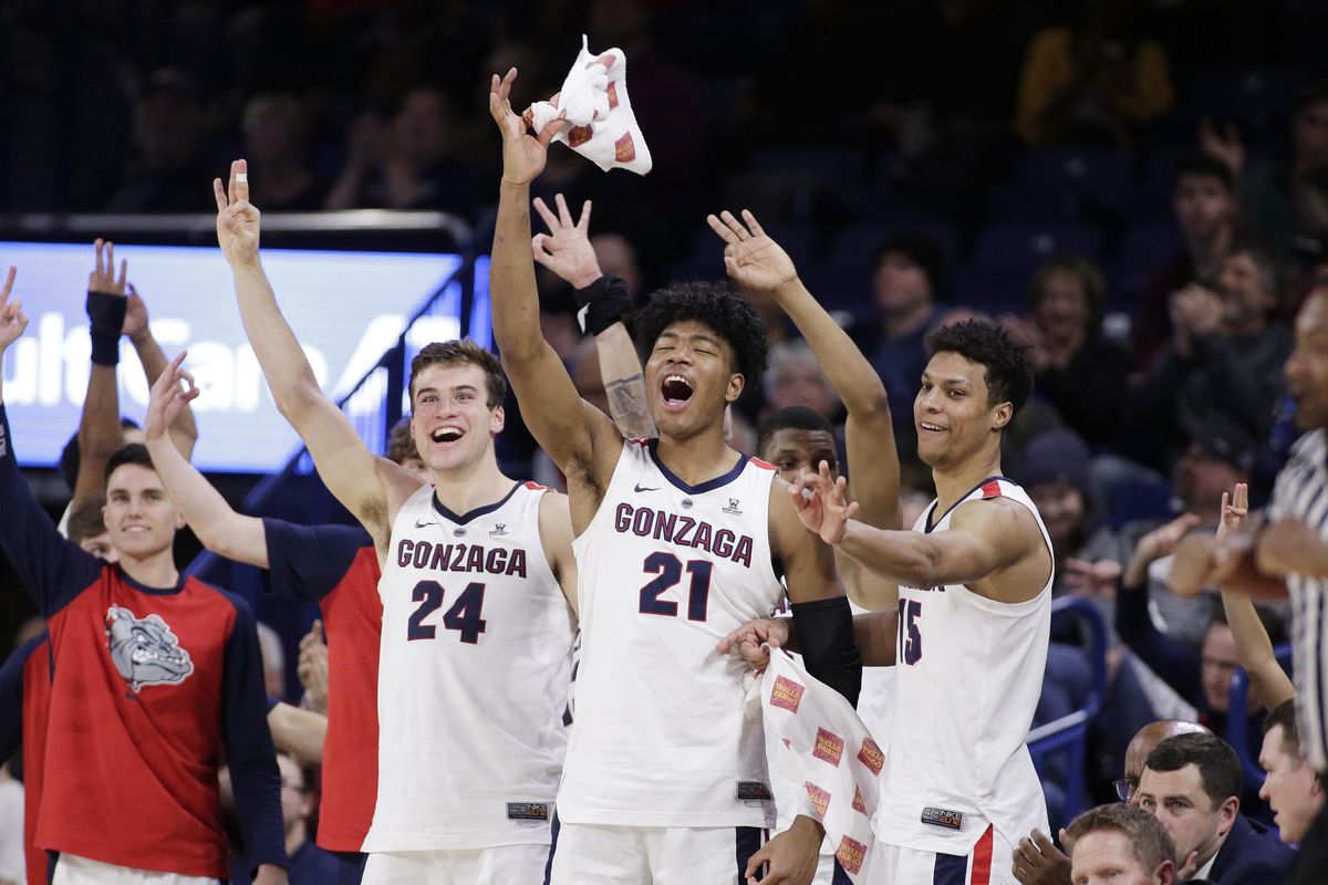 Gonzaga’s Corey Kispert (24), forward Rui Hachimura (21) and forward Brandon Clarke (15) celebrate on the bench during the second half of Friday’s win over Denver. (YOUNG KWAK / AP)
