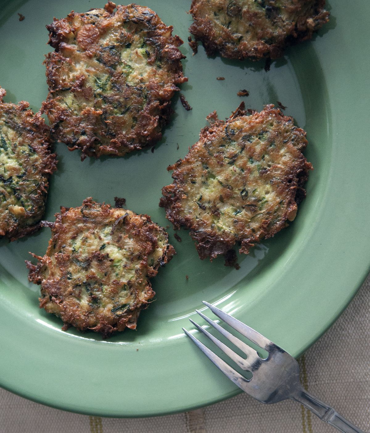 These paleo-friendly zucchini fritters are made quickly. Jalapeno, cilantro, cumin and coriander add plenty of flavor.  (The Spokesman-Review archive)