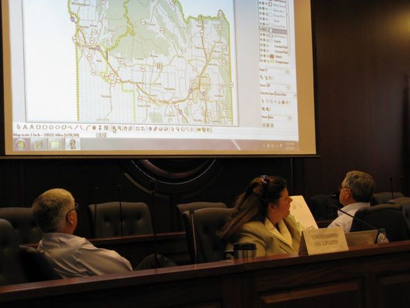 Idaho redistricting commissioners study proposed new congressional district lines on Friday. (Betsy Russell)