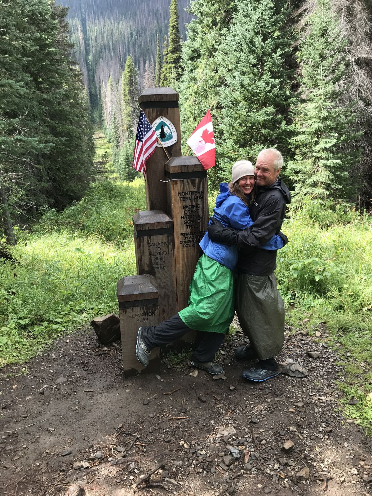 Jenny and Barry Brown finished the Pacific Crest trail at the U.S.-Canada border on Aug. 22. Their daughter Jo and son-in-law Matthew joined them for the last two weeks of the journey.  (Courtesy of Barry and Jenny Brown)