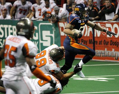 Boise’s Alex Guerrero and Nygel Rogers try to bring down Spokane’s Charles Dillon.  (Rajah Bose / The Spokesman-Review)