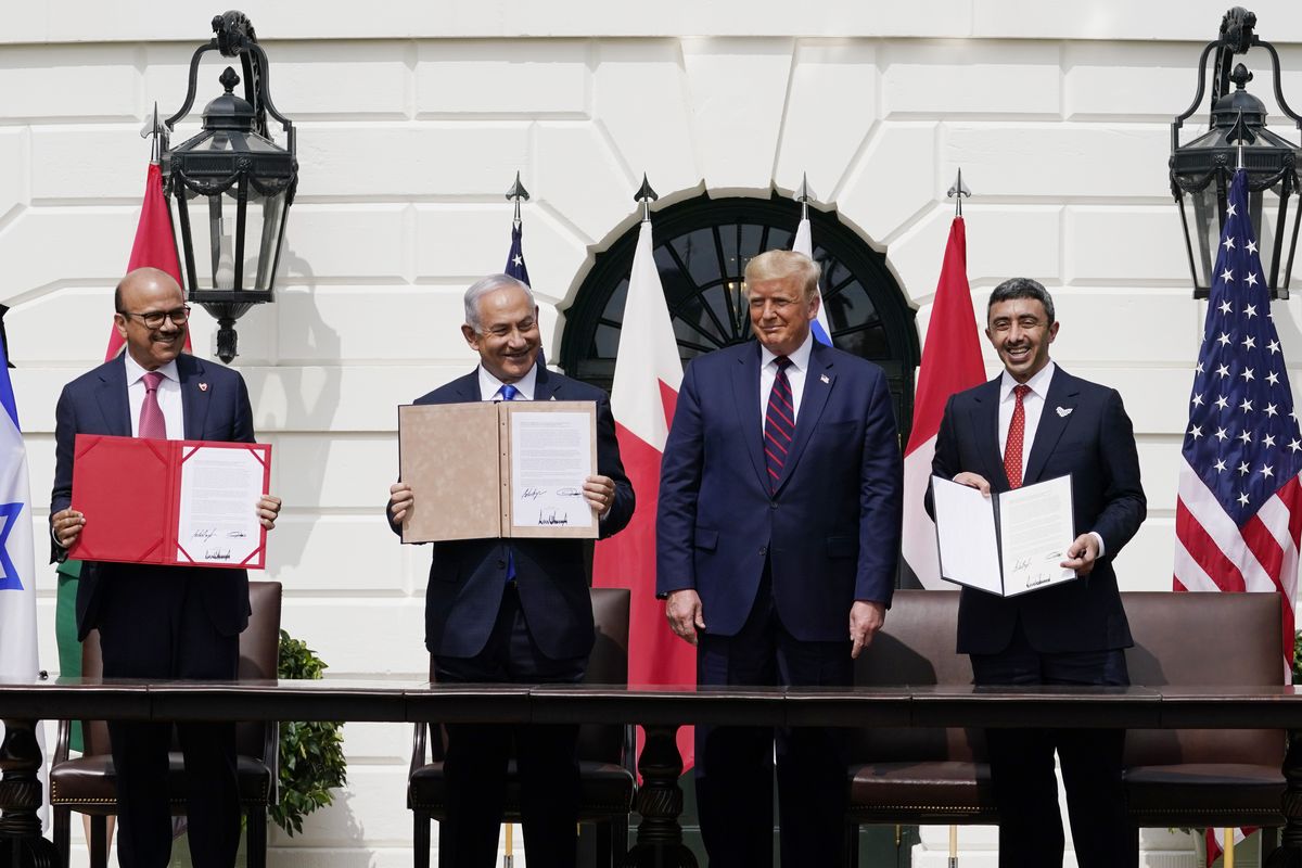 President Donald Trump, center, with from left, Bahrain Foreign Minister Khalid bin Ahmed Al Khalifa, Israeli Prime Minister Benjamin Netanyahu, Trump, and United Arab Emirates Foreign Minister Abdullah bin Zayed al-Nahyan, during the Abraham Accords signing ceremony on the South Lawn of the White House, Tuesday, Sept. 15, 2020, in Washington. (Alex Brandon)