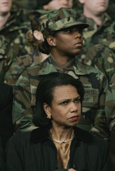 
Secretary of State Condoleezza Rice listens Saturday as President Bush speaks to U.S. troops stationed at Osan Air Base in South Korea. 
 (Associated Press / The Spokesman-Review)