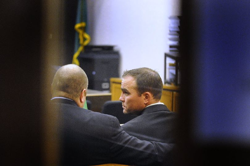 Photographed through the glass doors of Spokane County District Court, Spokane County Sheriff's Deputy Darin  Schaum,on right confers with lawyer Dallas Cooney, left, before pleading not guilty Wed. April 28, 2010 to drunken driving. COLIN MULVANY colinm@spokesman.com (Colin Mulvany / The Spokesman-Review)