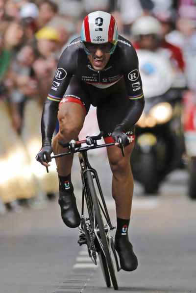 Fabian Cancellara of Switzerland strains as he crosses the finish line to win the prologue of the Tour de France cycling race. (Associated Press)