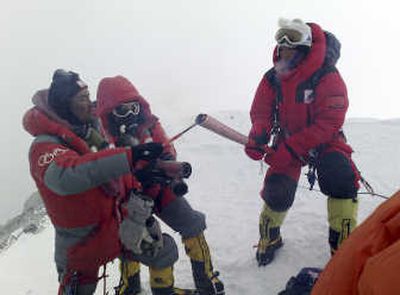 
In this photo released by China's Xinhua news agency, Norbu Zhamdu, left, lights the Olympic torch of the first torchbearer at the top of  Mount Everest today. Associated Press
 (Associated Press / The Spokesman-Review)