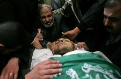 
Senior Hamas leader Mahmoud Zahar mourns over the body of his son Hussam, 24, during his funeral Tuesday in Gaza City.  Hussam Zahar was the second son of Mahmoud Zahar to be killed by Israel. Associated Press
 (Associated Press / The Spokesman-Review)