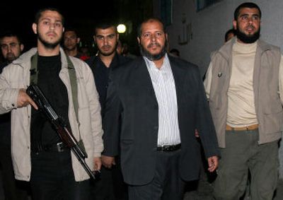 
Hamas lawmaker Khalil al-Haya, center, arrives at  the morgue where family members killed in an Israeli missile strike were  taken in Gaza City on Sunday. 
 (Associated Press / The Spokesman-Review)