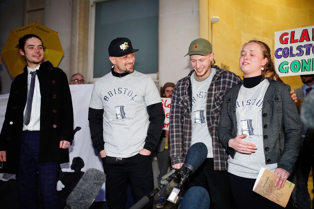 From left, Sage Willoughby, Jake Skuse, Milo Ponsford and Rhian Graham outside Bristol Crown Court, Bristol, England, Wednesday Jan. 5, 2021. The four anti-racism demonstrators were cleared Wednesday of criminal damage in the toppling of a statue of a 17th century slave trader during a Black Lives Matter protest in southwestern England 18 months ago.  (Ben Birchall)