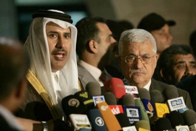 
Qatar's Foreign Minister Sheikh Hamad bin Jassim bin Jabr al-Thani, left, and Palestinian Authority President Mahmoud Abbas talk to the media Tuesday in Gaza City. 
 (Associated Press / The Spokesman-Review)