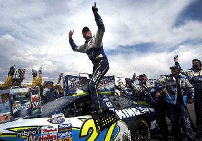 
David Green jumps on his car to celebrate his ninth career Busch Series victory at the ITT Industries 250.
 (Associated Press / The Spokesman-Review)