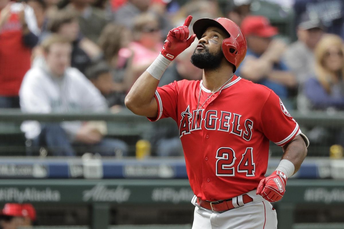 Los Angeles Angels’ Chris Young points upward as he crosses the plate after hitting a solo home run against the Seattle Mariners during the seventh inning Wednesday in Seattle. (Ted S. Warren / AP)