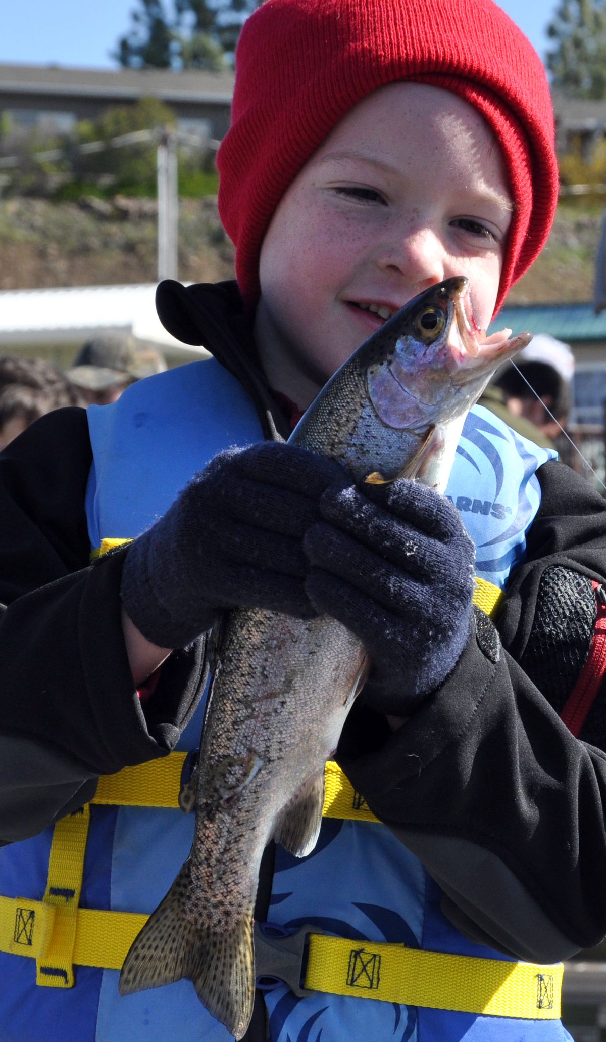 Justin Meadows, 5, of Spokane, prizes his first trout, caught off the dock at Klink’s Williams Lake Resort on Saturday. (Rich Landers)